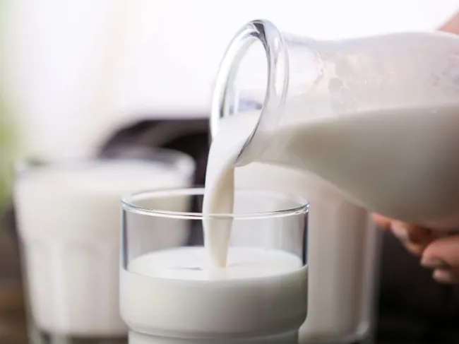 milk pouring into cup